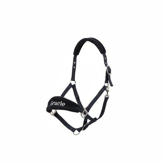 A black personalized head collar for horses with a soft padded headpiece, embroidered with the name 'Gracie'. It includes a matching cotton lead rope, adjustable noseband, and throat latch with a trigger clip.